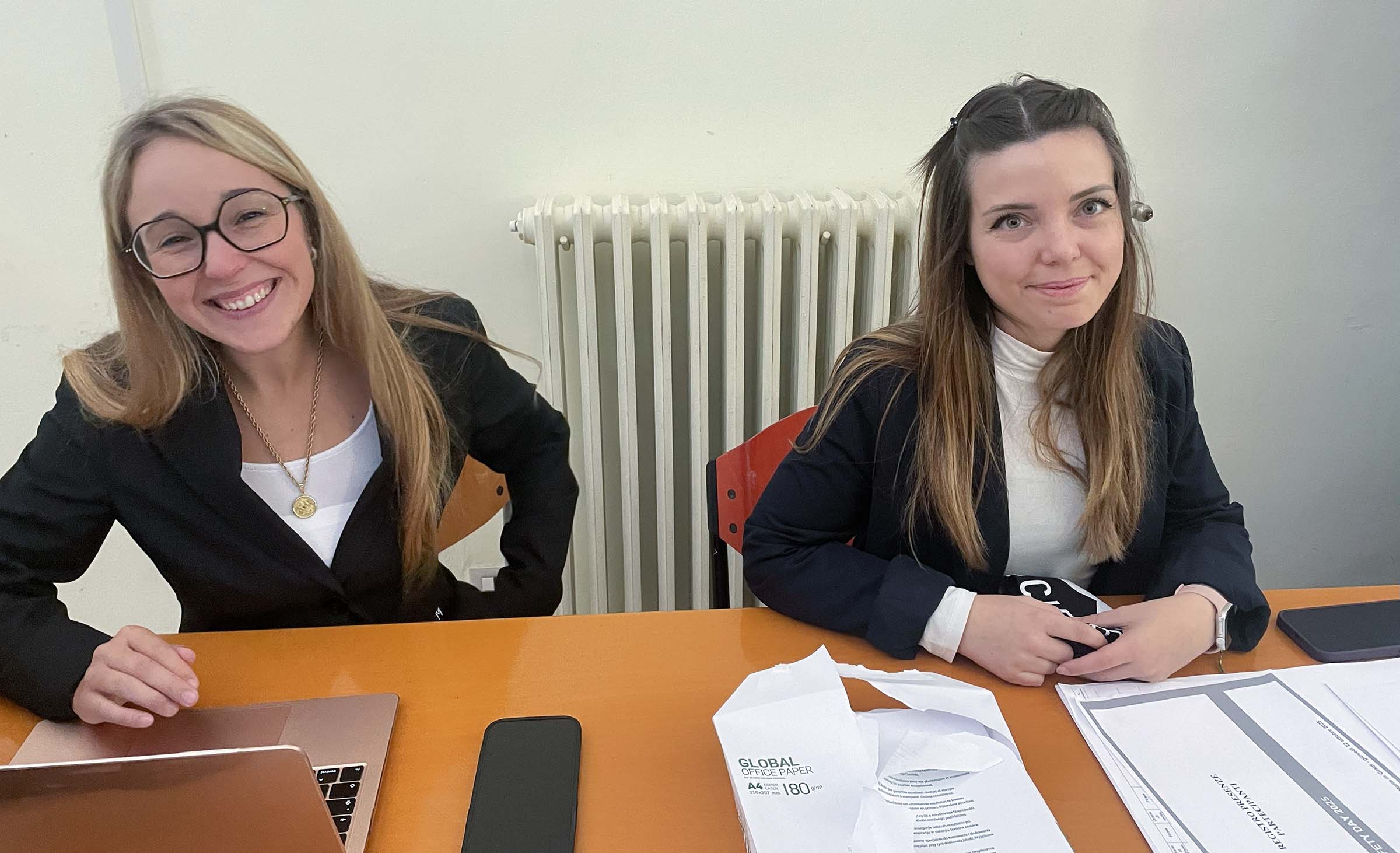 REGISTRATION_L two young and smiling students welcome the participants to the conference